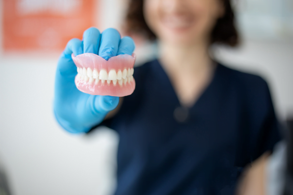 a person holding dentures